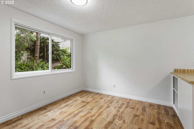 7124 SW Murray Blvd, Beaverton, OR 97008 - spare room with light wood-type flooring, a textured ceiling, and baseboards