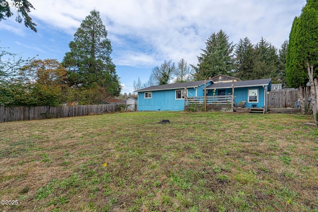 5053 NE 50th St, Neotsu, OR 97364 - rear view of house with a deck and a fenced backyard