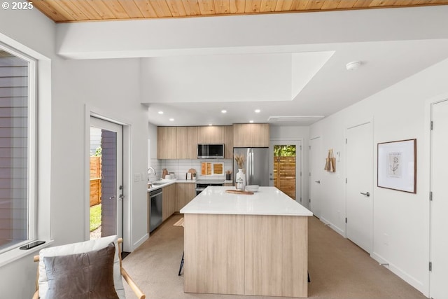 2415 NE 38th Ave Unit B, Portland, OR 97212 - kitchen with stainless steel appliances, modern cabinets, light carpet, light countertops, and decorative backsplash