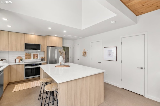 2415 NE 38th Ave Unit B, Portland, OR 97212 - kitchen featuring stainless steel appliances, light brown cabinetry, recessed lighting, modern cabinets, and a breakfast bar
