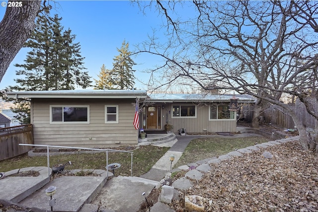 single story home featuring fence