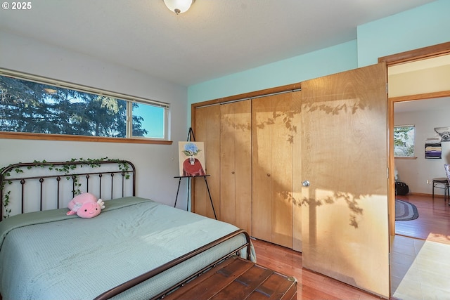 bedroom featuring light wood finished floors and a closet