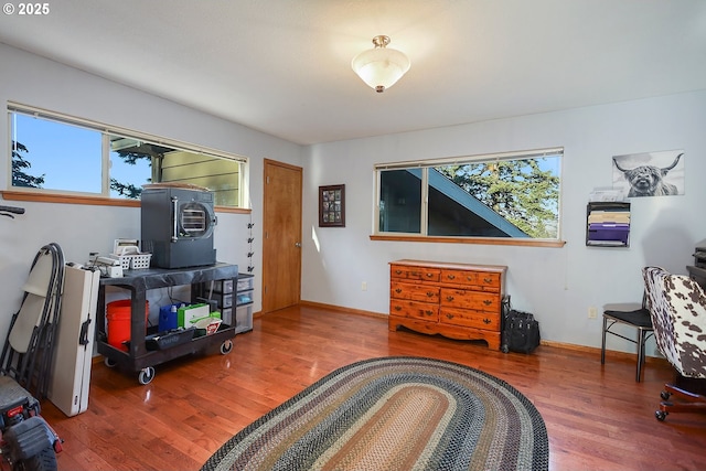 interior space featuring baseboards and wood finished floors