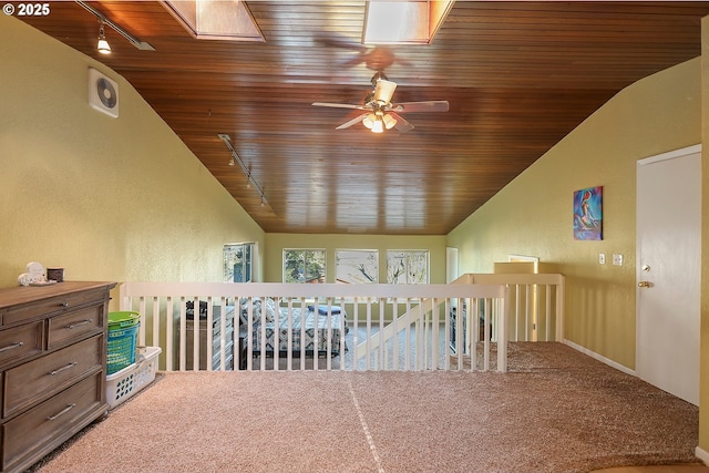 bonus room with wooden ceiling, a skylight, carpet floors, and a textured wall