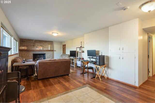 211 W 16th St, The Dalles, OR 97058 - living room featuring wood finished floors and a brick fireplace