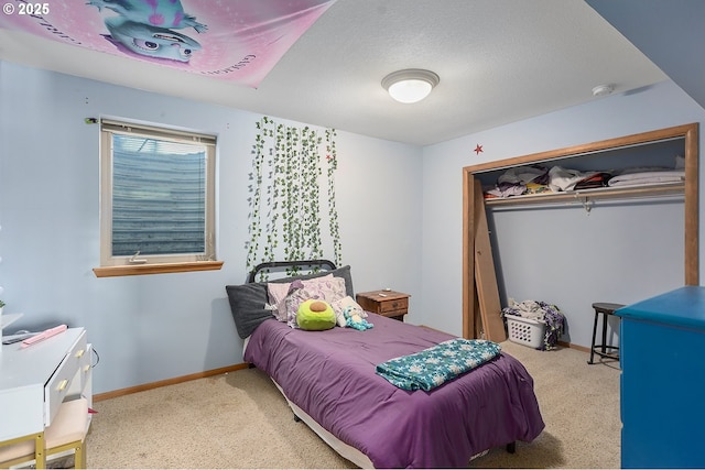 bedroom featuring carpet, a closet, and baseboards