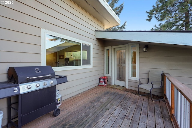 wooden deck with a grill