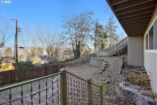 view of yard with stairway and a fenced backyard