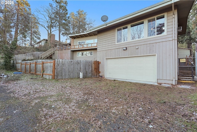 211 W 16th St, The Dalles, OR 97058 - rear view of property with an attached garage, fence, and driveway