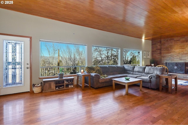 living room with a healthy amount of sunlight, hardwood / wood-style flooring, and wood ceiling