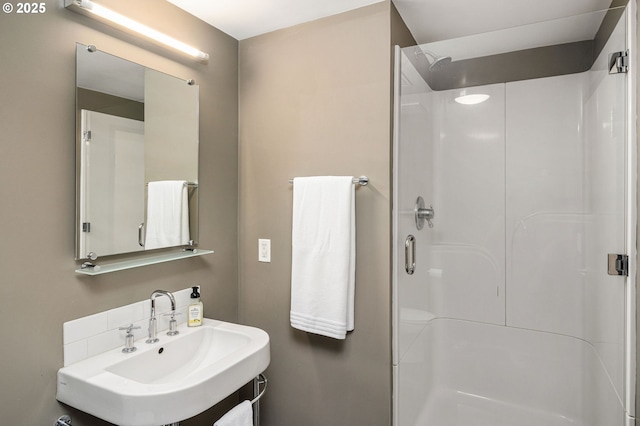 bathroom featuring a shower stall and a sink