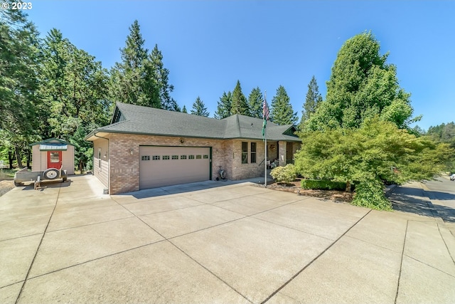 48482 E Meadow Way, Oakridge, OR 97463 - ranch-style home with brick siding, a garage, driveway, and roof with shingles