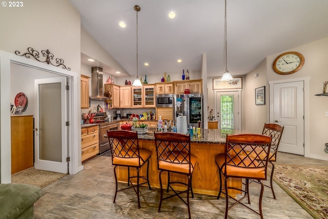 48482 E Meadow Way, Oakridge, OR 97463 - kitchen featuring wall chimney exhaust hood, stainless steel appliances, a breakfast bar area, a kitchen island, and glass insert cabinets