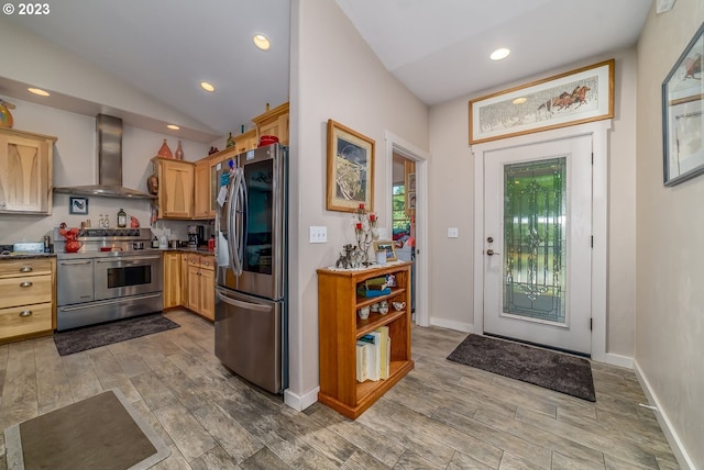 48482 E Meadow Way, Oakridge, OR 97463 - kitchen with wall chimney exhaust hood, appliances with stainless steel finishes, wood finished floors, recessed lighting, and dark countertops