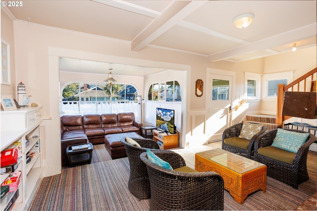 living room with beamed ceiling, coffered ceiling, and a healthy amount of sunlight