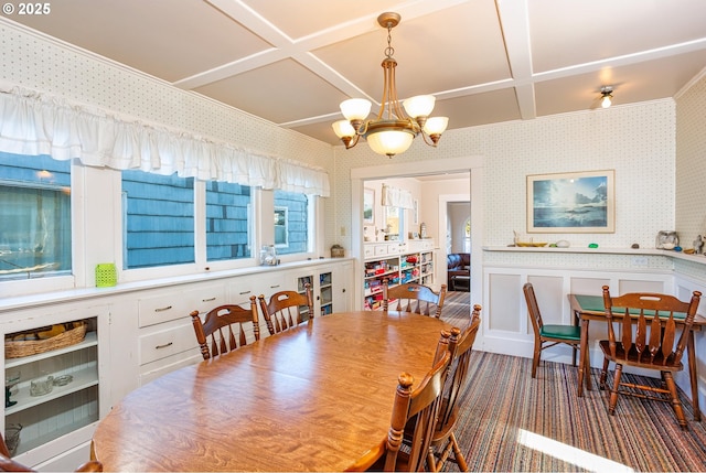 dining area with beamed ceiling, coffered ceiling, and a chandelier