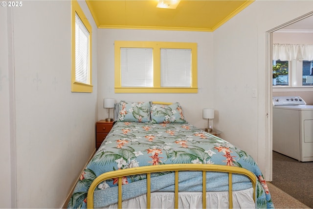 carpeted bedroom with crown molding and washer / dryer