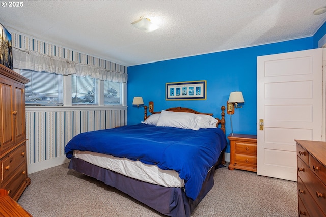 bedroom featuring light colored carpet and a textured ceiling