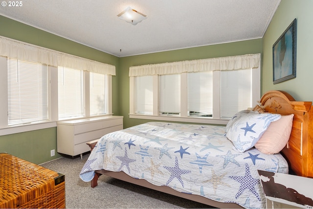 bedroom with carpet and a textured ceiling