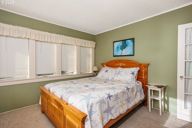 bedroom featuring ornamental molding, a textured ceiling, and carpet flooring