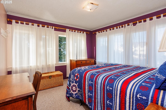 bedroom with light carpet and a textured ceiling