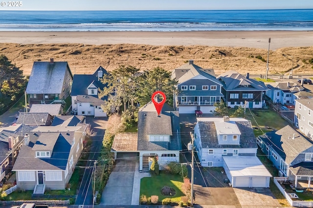 birds eye view of property with a water view and a view of the beach