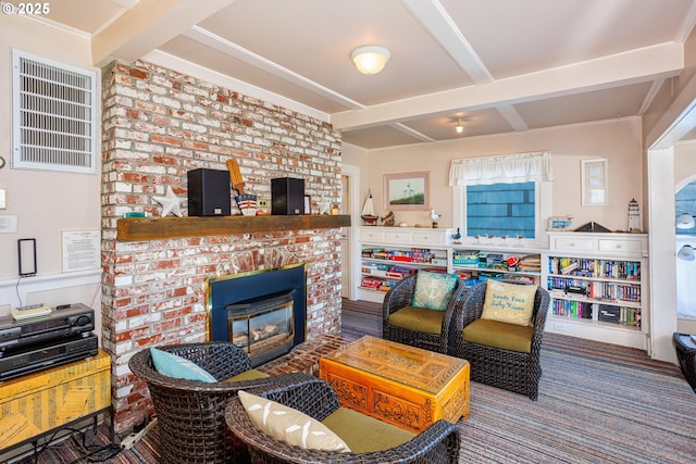 living room with beamed ceiling and a fireplace