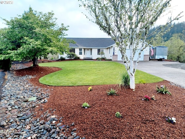 single story home with a garage, a front yard, and driveway