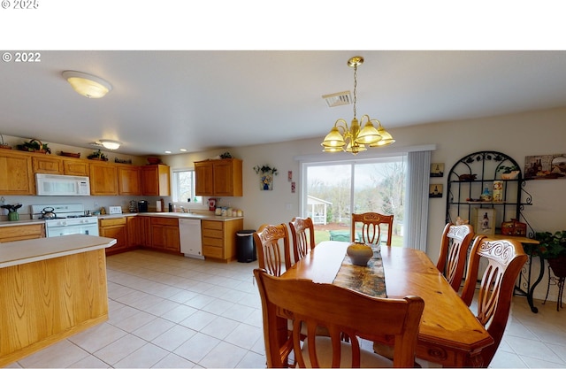 dining room featuring light tile patterned floors, visible vents, and a chandelier