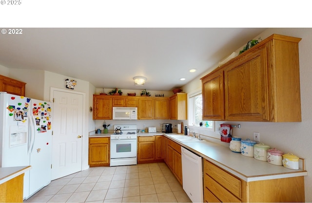 kitchen with white appliances, light tile patterned floors, light countertops, and a sink