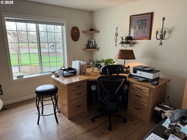 office space with light wood-type flooring and baseboards