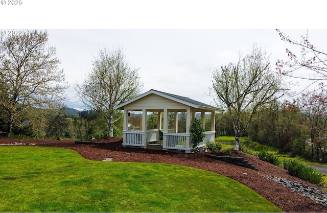 view of front of property featuring a gazebo and a front yard