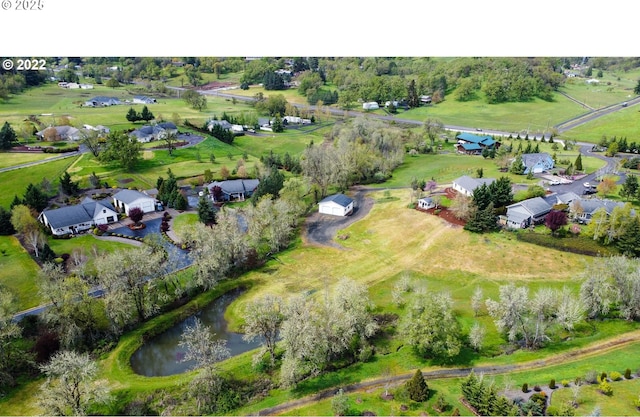 birds eye view of property featuring a rural view and a water view