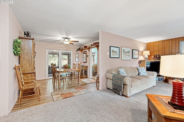 29806 Lusk Rd, Eugene, OR 97405 - living room featuring ceiling fan, a textured ceiling, light carpet, and light wood finished floors