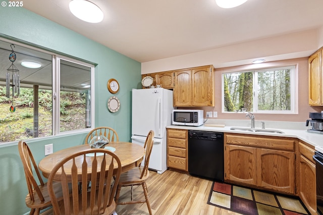 29806 Lusk Rd, Eugene, OR 97405 - kitchen with white appliances, a sink, light wood-style flooring, light countertops, and brown cabinets