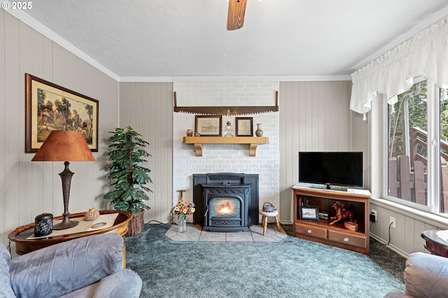 29806 Lusk Rd, Eugene, OR 97405 - carpeted living area featuring a wood stove, crown molding, wooden walls, and a ceiling fan
