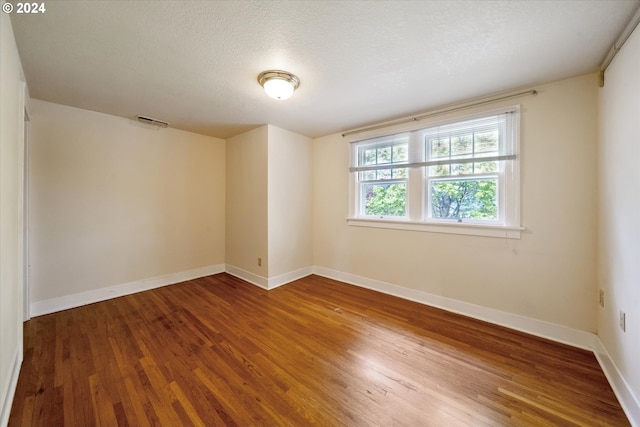 1224 SE Malden St, Portland, OR 97202 - empty room with wood finished floors and a textured ceiling