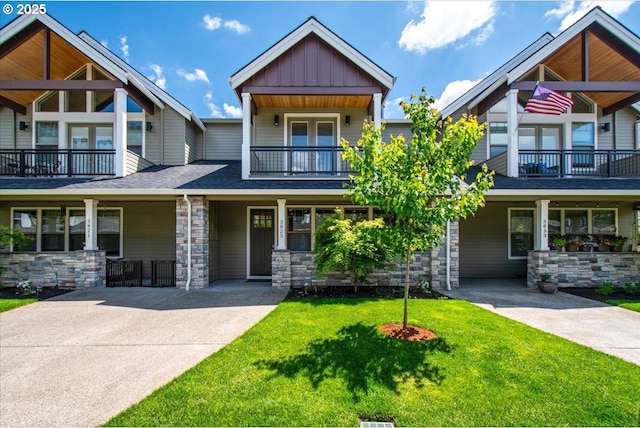 3825 NW 74th Ave Unit 59, Camas, WA 98607 - craftsman house featuring stone siding, a balcony, a front yard, board and batten siding, and driveway
