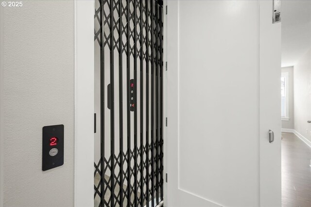 3825 NW 74th Ave Unit 59, Camas, WA 98607 - elevator with a gate, baseboards, and wood finished floors
