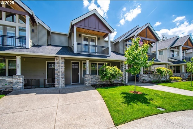 3825 NW 74th Ave Unit 59, Camas, WA 98607 - craftsman-style home with board and batten siding, a balcony, covered porch, a front yard, and stone siding