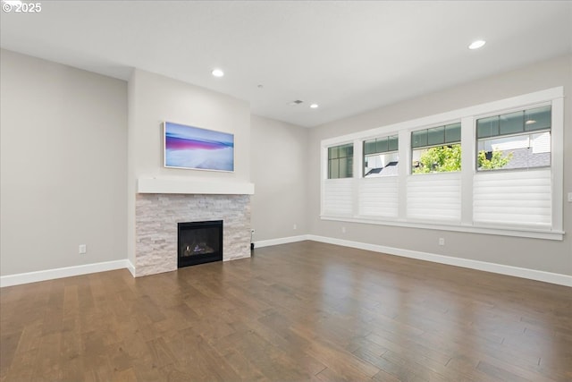 3825 NW 74th Ave Unit 59, Camas, WA 98607 - unfurnished living room featuring dark wood-style floors, baseboards, recessed lighting, and a fireplace