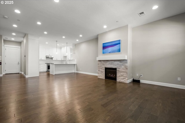 3825 NW 74th Ave Unit 59, Camas, WA 98607 - unfurnished living room with dark wood-type flooring, a fireplace, baseboards, and recessed lighting