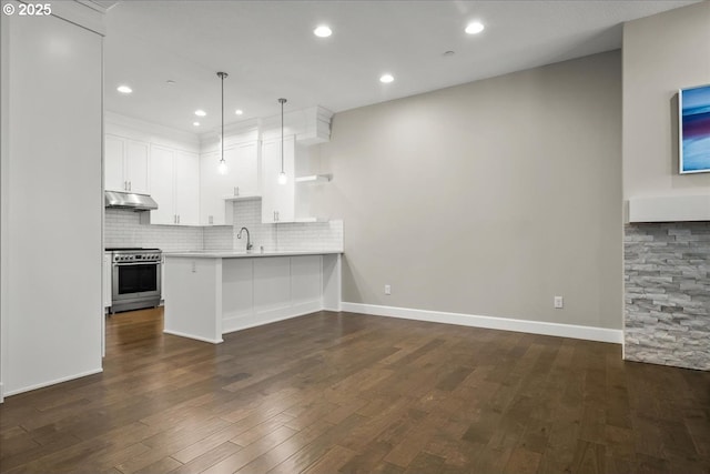 3825 NW 74th Ave Unit 59, Camas, WA 98607 - kitchen featuring high end stainless steel range, light countertops, a peninsula, backsplash, and dark wood-style flooring