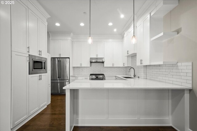 3825 NW 74th Ave Unit 59, Camas, WA 98607 - kitchen featuring appliances with stainless steel finishes, open shelves, a sink, under cabinet range hood, and a peninsula