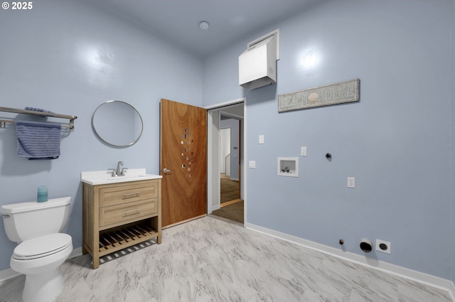 bathroom with toilet, baseboards, and vanity