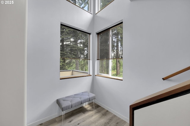 stairs featuring wood finished floors and baseboards