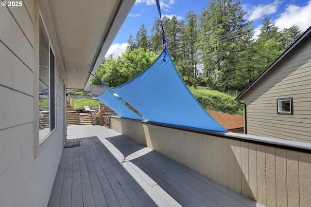 wooden deck with view of wooded area