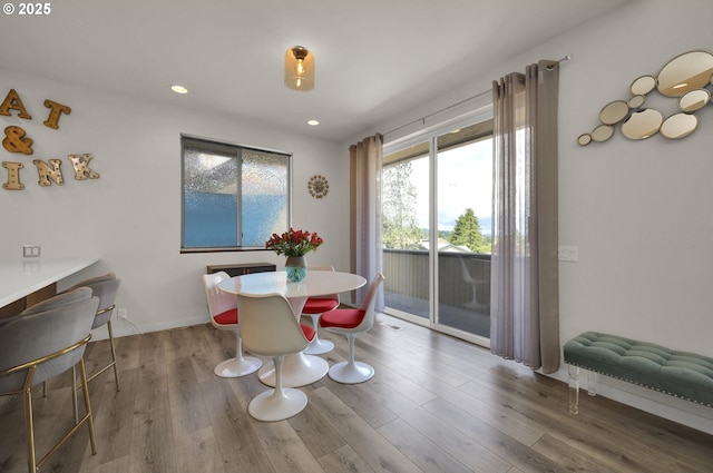 dining space with wood finished floors, recessed lighting, and baseboards