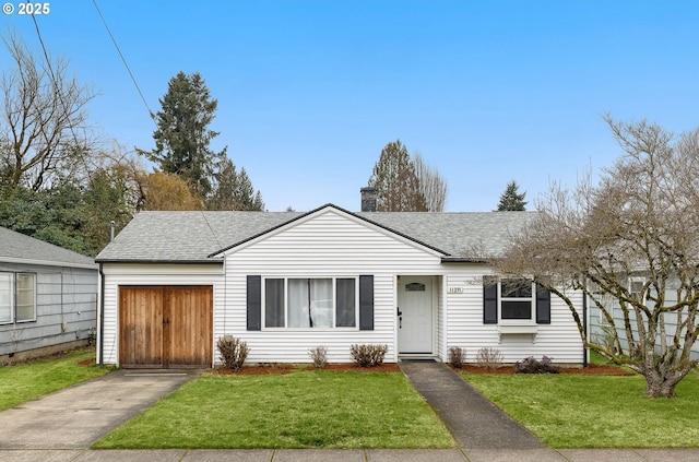 ranch-style house featuring a garage and a front lawn