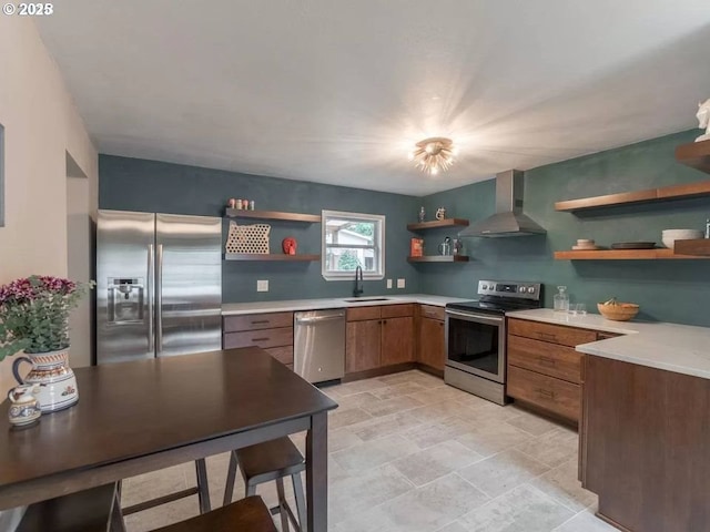 kitchen with sink, wall chimney exhaust hood, and appliances with stainless steel finishes